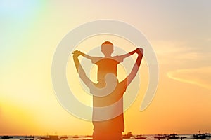 Father and son on sunset beach