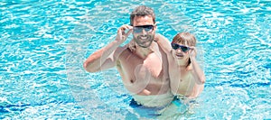 Father and son in swimming pool, banner with copy space. happy family of dad and child having fun in summer swimming