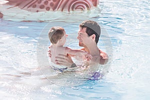 Father with son in the swimming pool. Father`s day. Parent