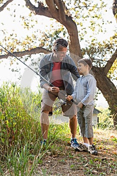 Father and son talking while fishing in the river