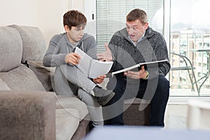 Father and son teenager can not solve school assignments