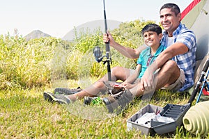 Father and son beside tent