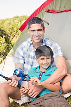 Father and son beside tent