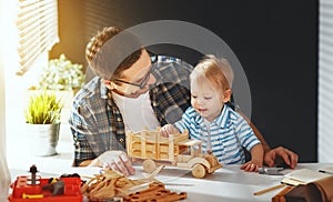 Father and son toddler gather craft a car out of wood and play