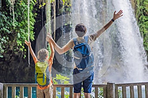 father and son tourists on the background of Duden waterfall in Antalya. Famous places of Turkey. Apper Duden Falls