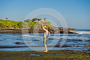 Father and son tourists on the background of Tanah Lot - Temple