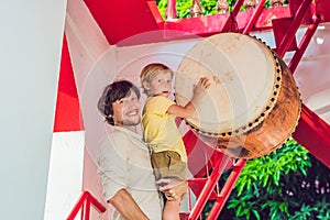 Father and son tourists look at Wat Chalong is the most important temple of Phuket