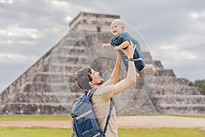 Father and son tourists observing the old pyramid and temple of the castle of the Mayan architecture known as Chichen