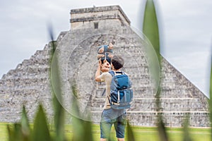 Father and son tourists observing the old pyramid and temple of the castle of the Mayan architecture known as Chichen