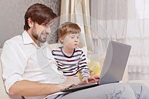 Father and son use computer