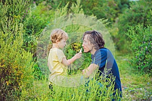 Father and son use a spray from an allergy because of an allergy