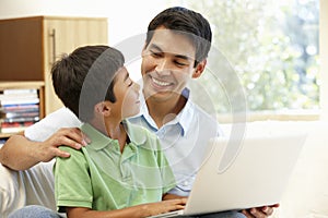 Father and son using laptop