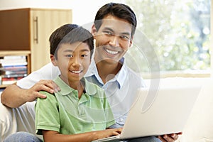 Father and son using laptop