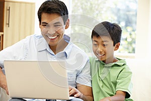 Father and son using laptop