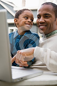 Father and son using laptop