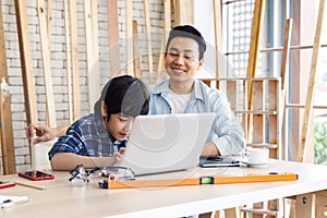 Father and son using laptop computer.