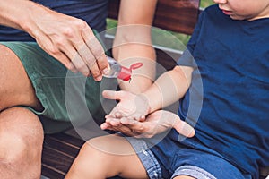 Father and son using wash hand sanitizer gel pump dispenser