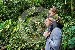 Father and son visit the botanical garden's tropical greenhouse