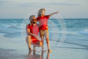 Father and son walk in sea beach. Concept of friendly family. Happy family on beach, summer holiday vacation. Dad with