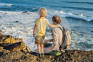 Father and son are walking along the cosmic Bali beach.. Portrait travel tourists - dad with kids. Positive human