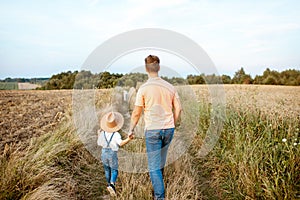 Father and son walking in the field