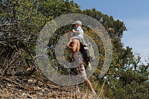 Father and son walking in mountains. Travelling background. Summer time. Trecking