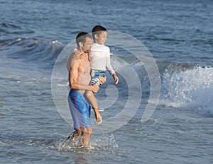 Father and son walking in the ocean