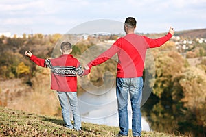 father and son walking in the park in autumn