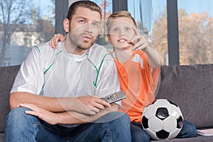 Father and son watching soccer match