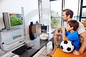 Father and son watching tv together