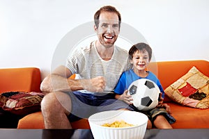 Father and son watching tv together