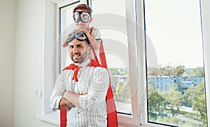 Father and son at the window in the room.