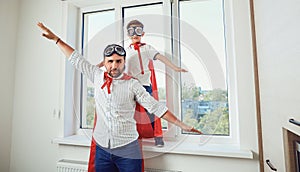 Father and son at the window in the room.