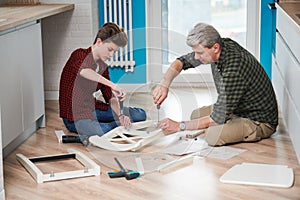 Father and son work together. kitchen chair assembling