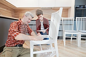 Father and son work together. kitchen chair assembling