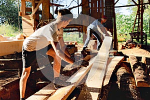Father and son working together in a sawmill