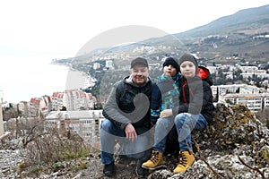 Father with sons on background of Gurzuf on Mount Bolgatura