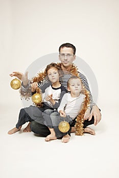 Father with sons and christmas decoration