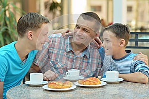 Father and sons having breakfast