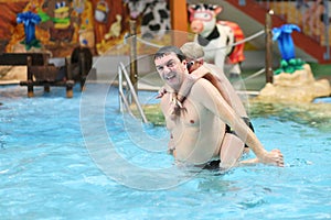 Father and sons having fun in swimming pool