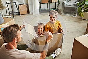 Father and Sons Playing with Boxes