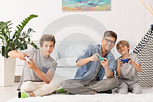 Father and sons playing video games