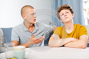 Father soothes teenager son after quarrel
