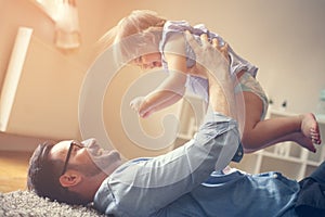 Father spending time with his little baby at home.