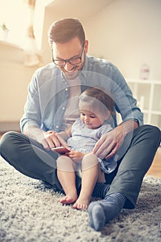 Father spending time at home with his little baby.