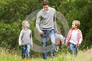 Father Taking Children On Picnic In Countryside