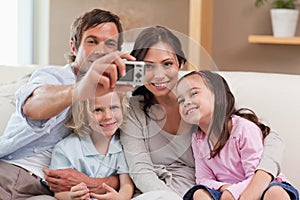 Father taking a picture of his family