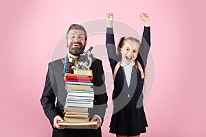 Father or teacher hold big stack school textbook notebook books. Happy excited preteen girl wears school uniform holding