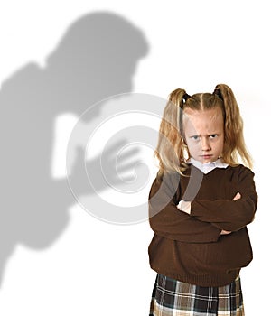 Father or teacher shadow screaming angry reproving young sweet little schoolgirl or daughter