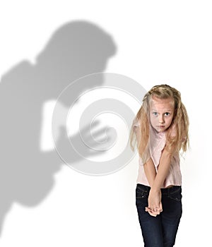 Father or teacher shadow screaming angry reproving young sweet little schoolgirl or daughter